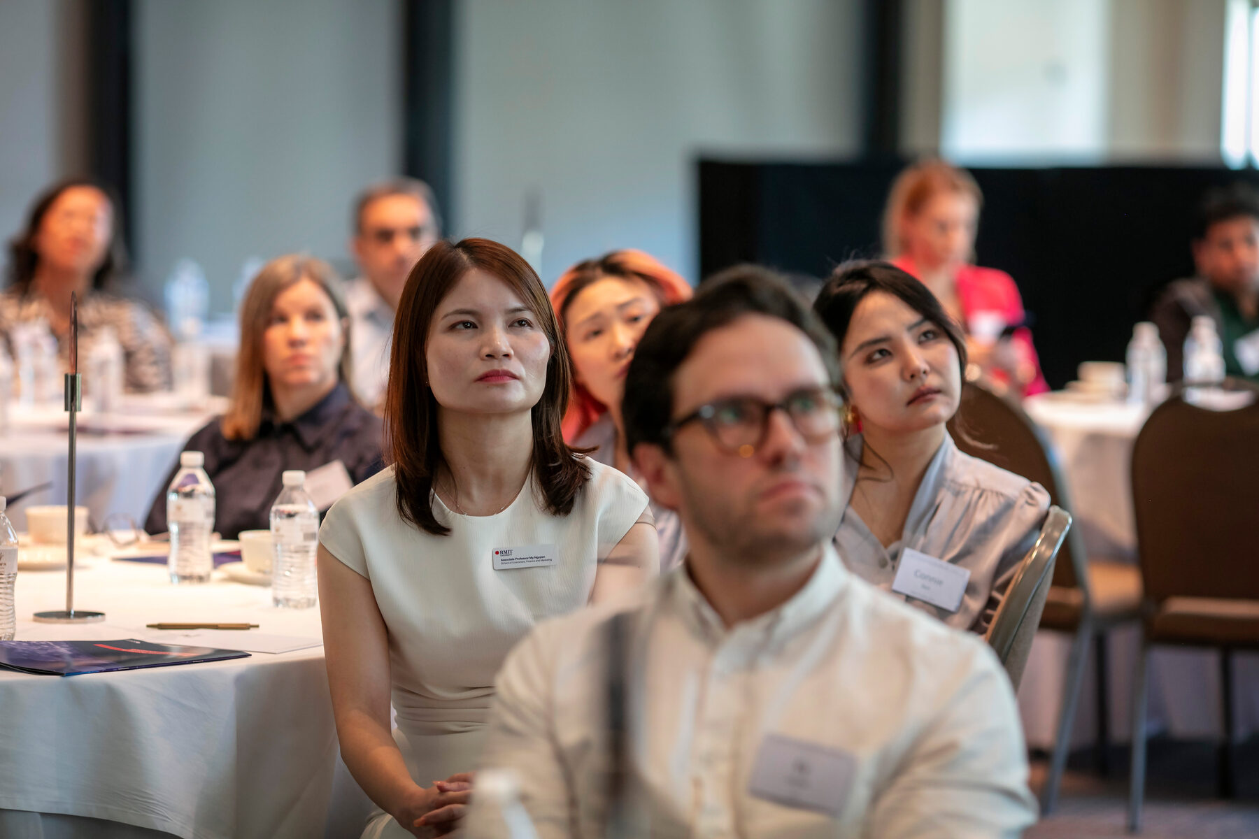 Audience members listening during a presentation